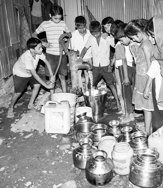 Queue and Rush of Children for Drinking Water collection at a public handpump in Mumbai, Maharashtra